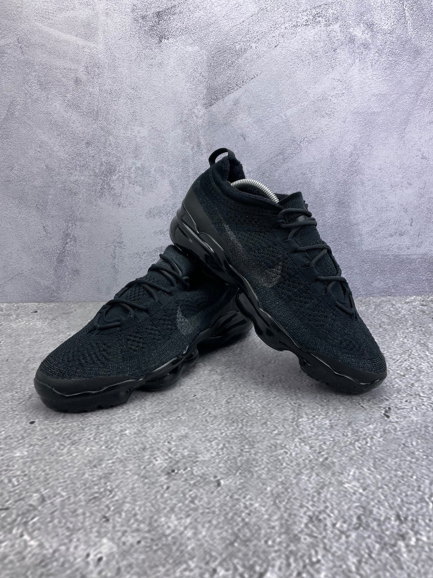 Nike Air VaporMax 2023 Flyknit Triple Black - buty sportowe, para butów, widok z boku na tle studyjnym