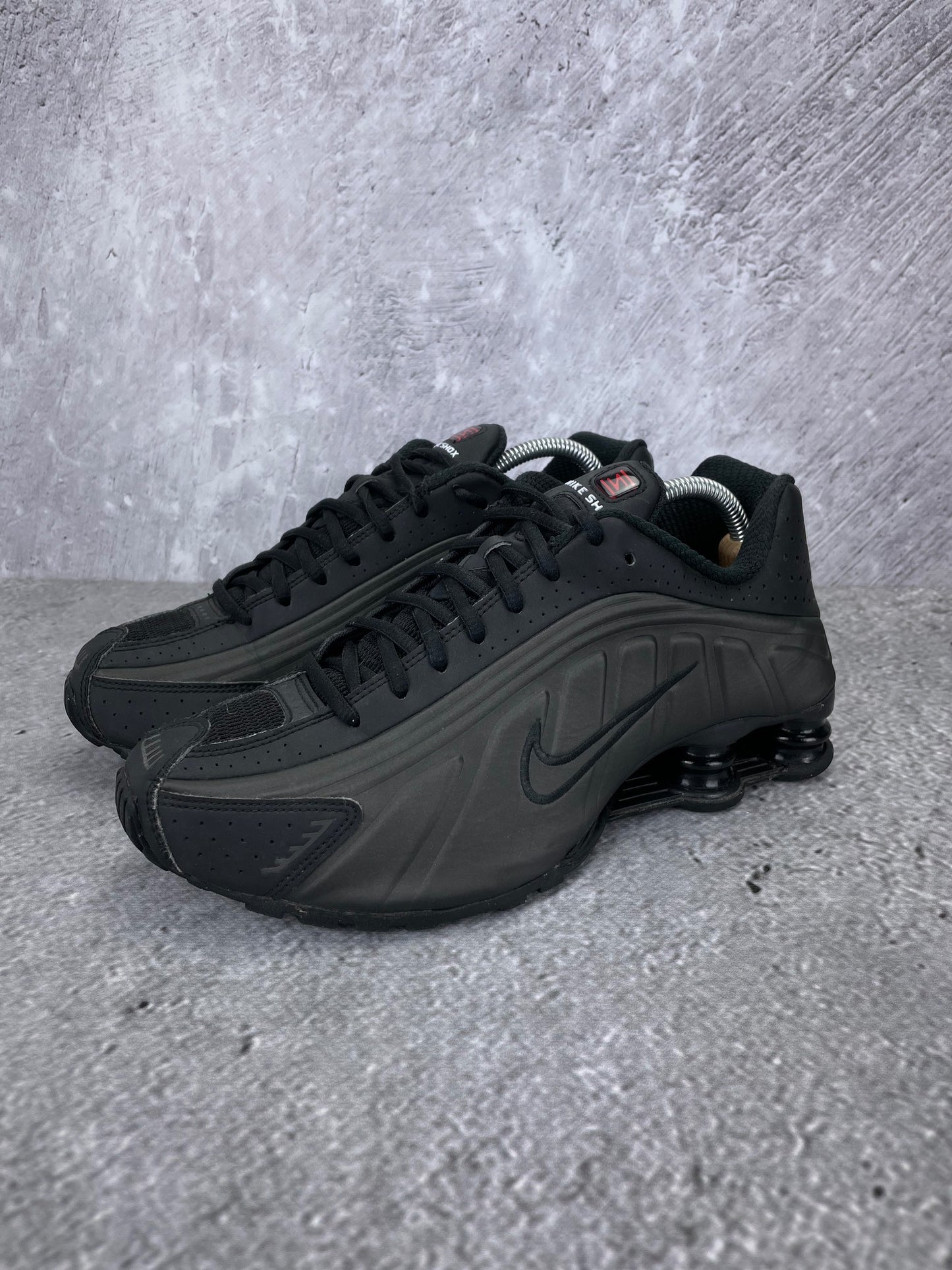Nike Shox R4 Triple Black - buty sportowe, widok z boku na tle studyjnym